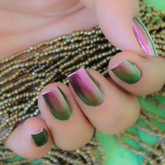 Hand with nails painted in multichrome polish