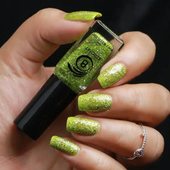 Bottle of  parrot green crushed metallic foil nail polish .